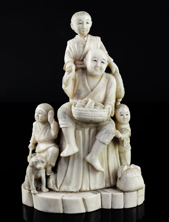 A Japanese walrus ivory okimono of a family, early 20th century, 16.8cm